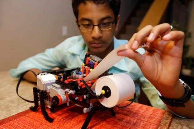 Shubham Banerjee works on his lego robotics braille printer at home Tuesday, Jan. 6, 2015, in Santa Clara, Calif. Banerjee launched a company to develop a low-cost machine to print Braille materials for the blind. It's based on a prototype he built with his Lego robotics kit for a school science fair project. Last month, tech giant Intel Corp. invested in his startup, Braigo Labs, making the 8th grader the youngest entrepreneur to receive venture capital funding. 