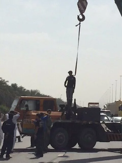 A policeman has saved the life of a crane driver who threatened to hang himself in the middle of a busy road